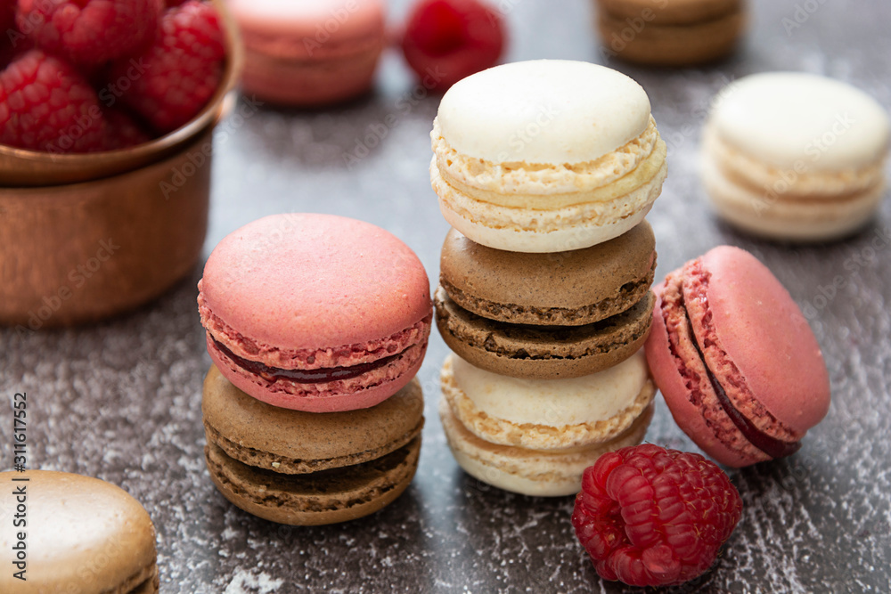 Heap of macarons isolated on dark background. Healthy cake dessert made from almond flour. Raspberry macaroons cookies. Heap of macarons isolated on dark background. Healthy cake dessert made from almond flour. Raspberry macaroons cookies.