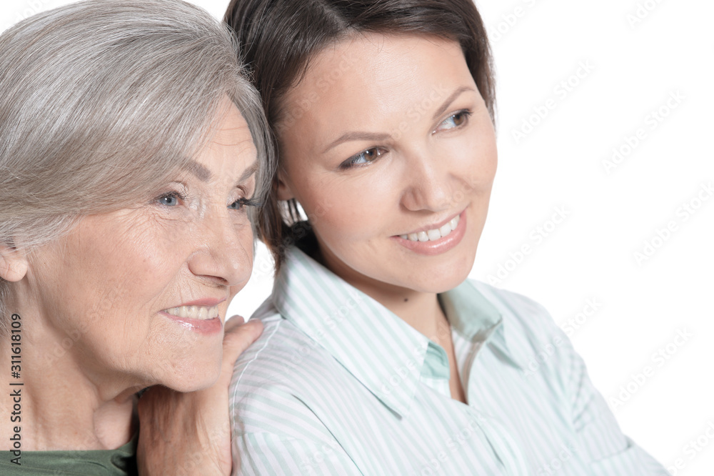 Close up portrait of mother and her adult daughter hugging isolated on white Close up portrait of mother and her adult daughter hugging isolated on white