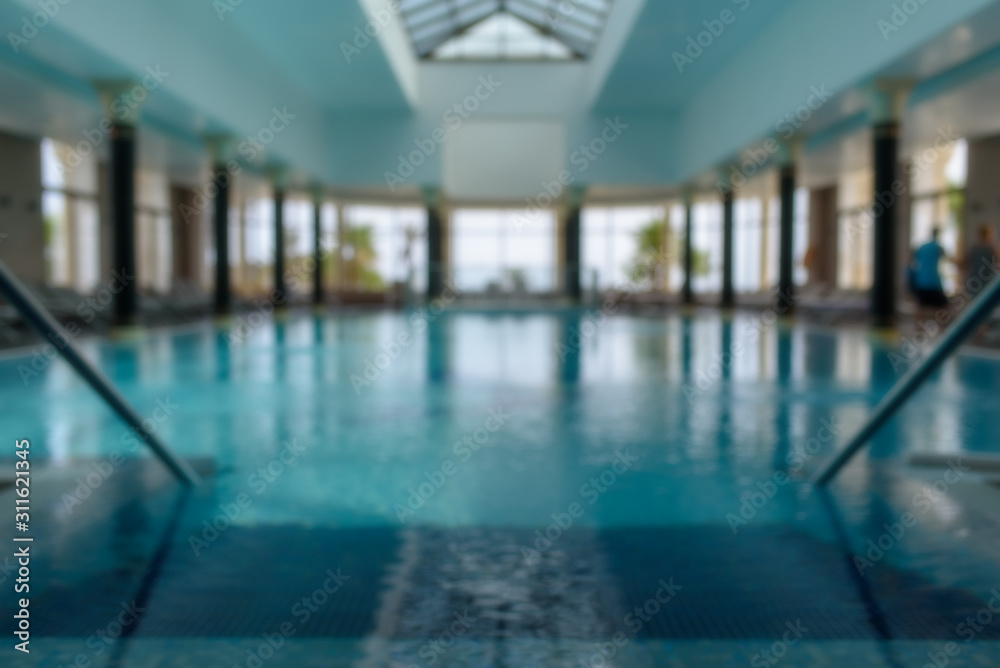 Indoor swimming pool in blurry background. Abstract swimming pool in fitness centre.. Indoor swimming pool in blurry background. Abstract swimming pool in fitness centre..