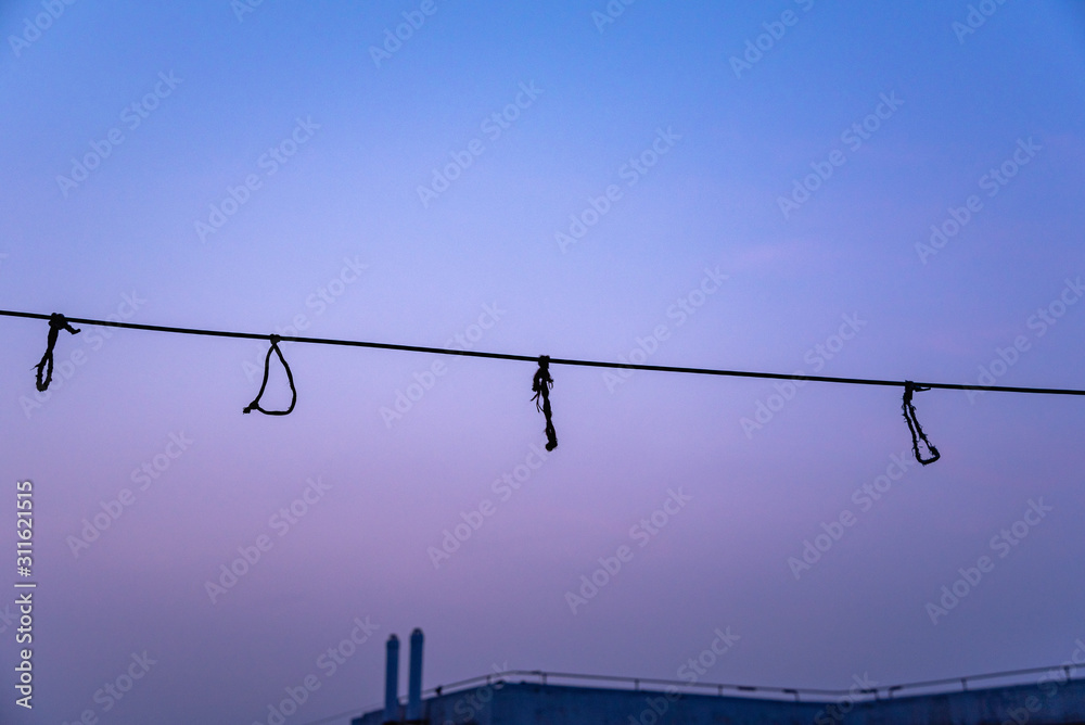 custom made wallpaper toronto digitalfour knots on the clothesline hanging in the wind, shot on the roof of a residential building