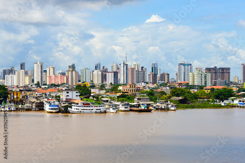 Belem / Brazil - May 14,2013. View of fishing harbor in Belem, many colorful fishing boats and rich building in background photo