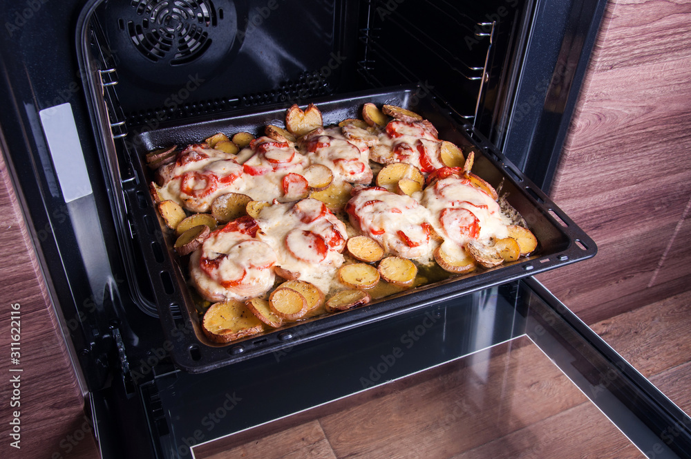 Pork meat with vegetables cooked in the oven. Home kitchen Pork meat with vegetables cooked in the oven. Home kitchen