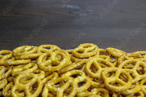 Crunchy pretzels on a dark wooden background. German beer snack