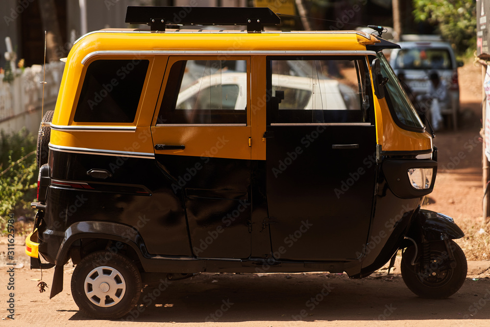 Fototapeta premium Tuk-tuk. side view. Taxi in India and Sri-lanka. Type of transport in Asia.
