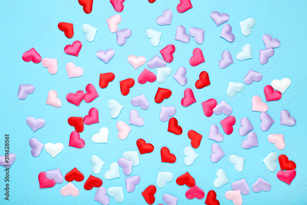 Colorful small hearts on blue background
