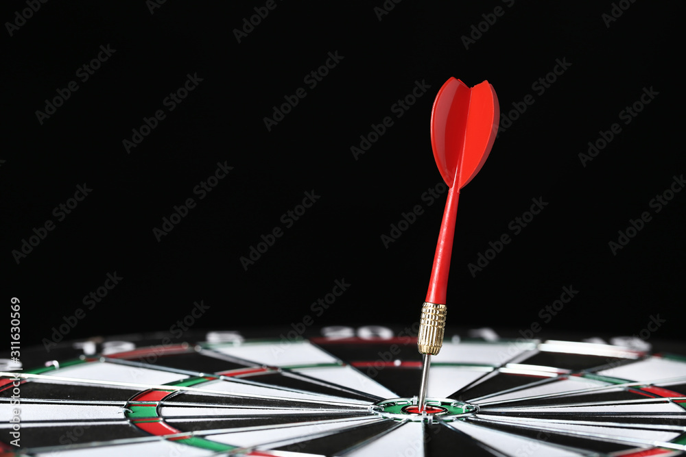 Dartboard with darts on black background Dartboard with darts on black background