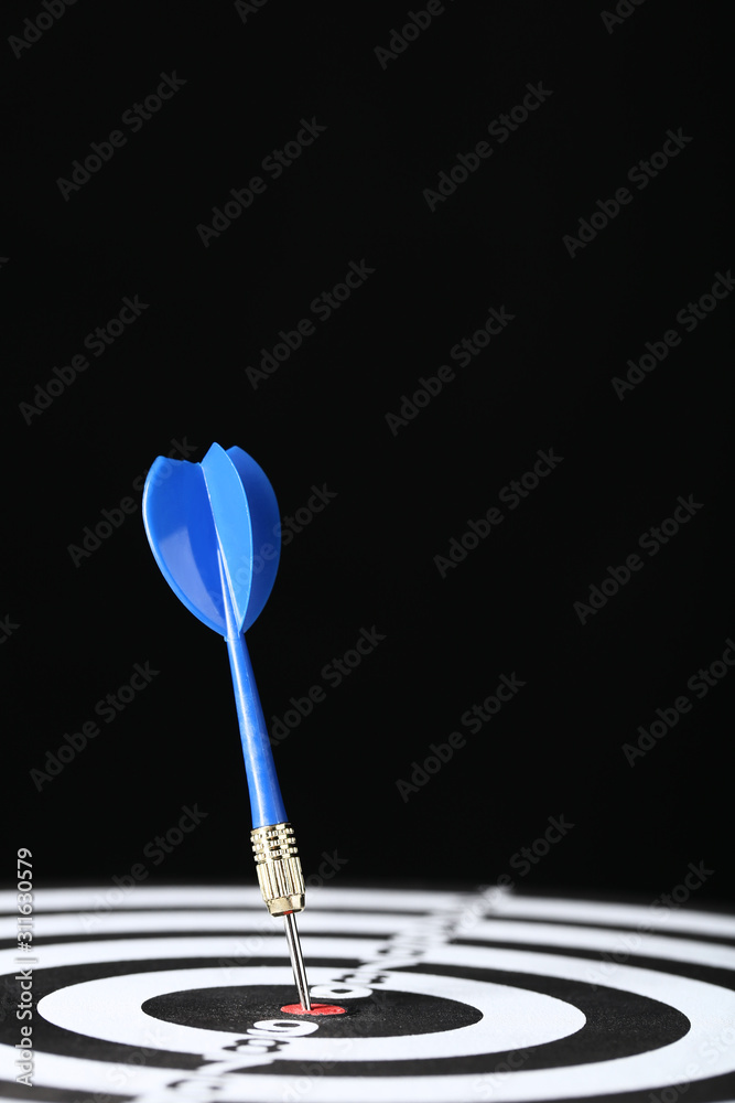 Dartboard with darts on black background Dartboard with darts on black background