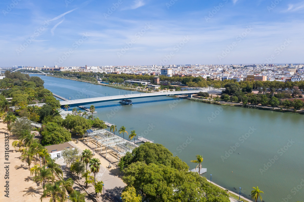 The ship goes on the river of the city of Seville