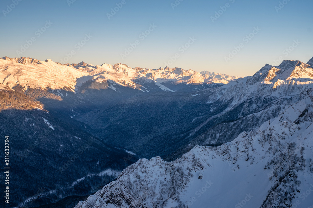 Evening in the mountains. Winter sunset in the Caucasus mountains.