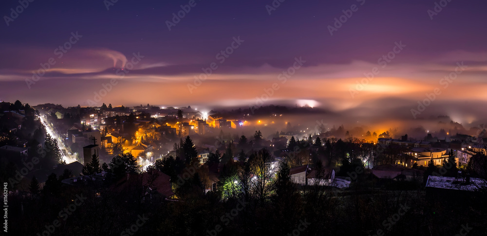 Foggy city at night from above