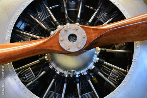 Close up of a radial engine on a vintage wooden propeller airplane.