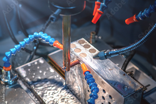 CNC machine cutting metal parts by water jet pressure photo