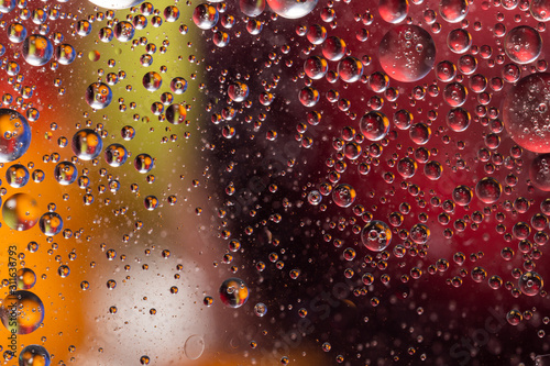 closeup of water and oil similar to space objects on a background of red ball