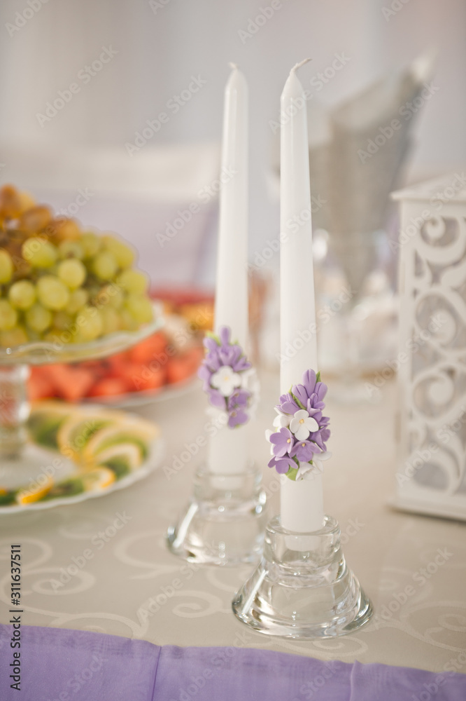 Fototapeta premium Two candles decorated by the bride before the wedding 2206.
