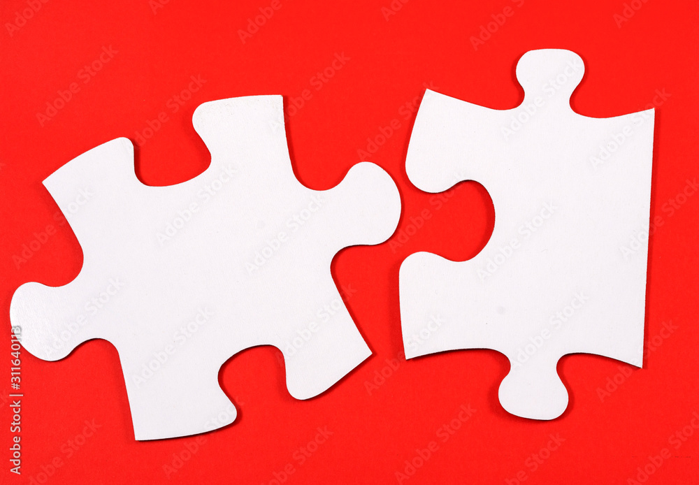 .two puzzles on a red background .two puzzles on a red background