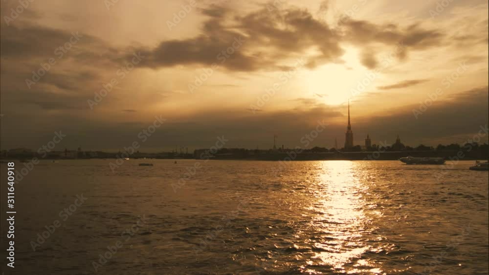 View of Neva river in St. Petersburg, Russia. Tourist boats float on the river. Buildings near the Neva River Embankment. View of Neva river in St. Petersburg, Russia. Tourist boats float on the river. Buildings near the Neva River Embankment.