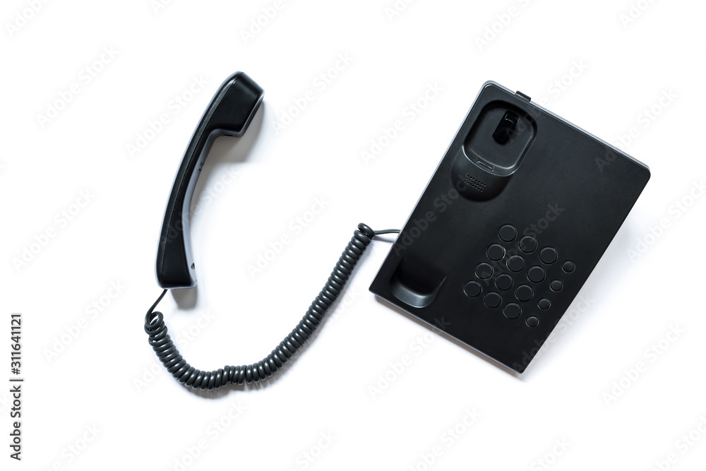 Simple modern push-button telephone of black color with a picked up handset and erased numbers and letters on the buttons isolated on a white background. Simple modern push-button telephone of black color with a picked up handset and erased numbers and letters on the buttons isolated on a white background.