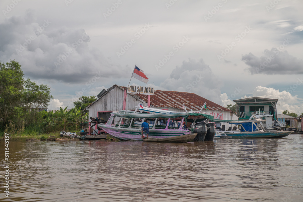 Fototapeta premium Boats and shops on the river, Manaus, Brazil, South America