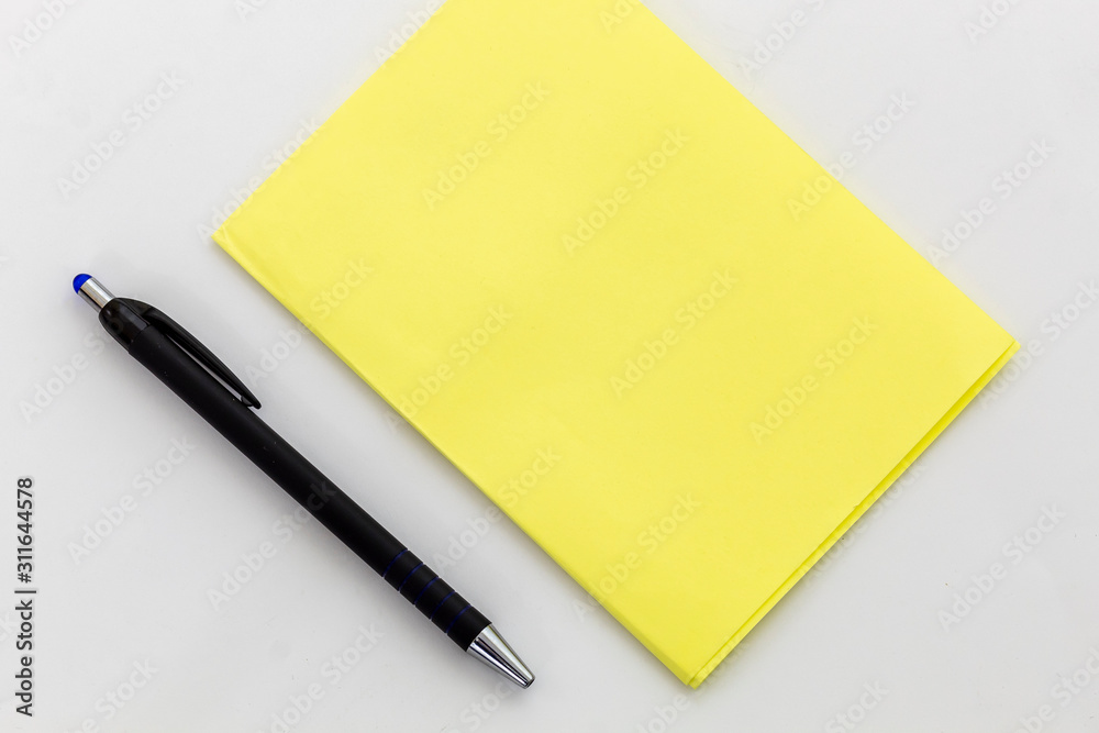 Blank Yellow Paper For Text and Black Pencil on White Background Blank Yellow Paper For Text and Black Pencil on White Background