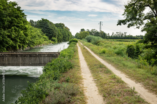 a dirt road along the Quintino Sella Irrigation Canal next to Garlasco, province of Pavia, Lombardy region, Italy