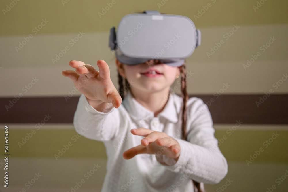 Girl with a virtual reality headset. The girl explores the world of virtual reality through video and games. Girl with a virtual reality headset. The girl explores the world of virtual reality through video and games.