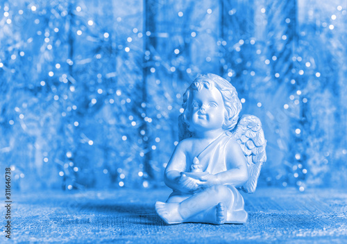 Tableau sur toile Blue Christmas decoration Little guardian angel lights background