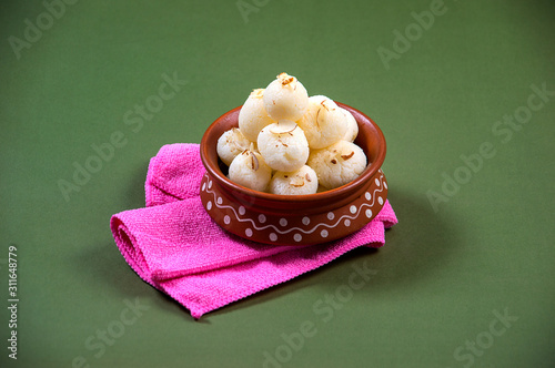 Indian Sweet - Rasgulla, Famous Bengali sweet in clay bowl with napkin photo