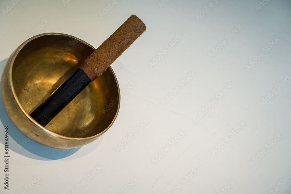 Original Tibetan bowl on a white table Original Tibetan bowl on a white table