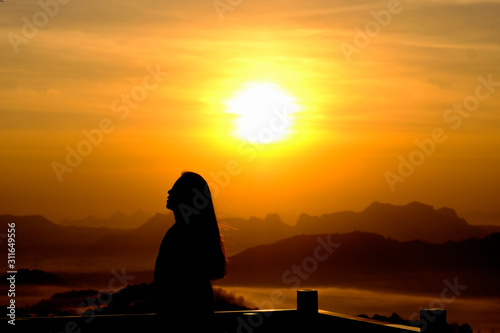 Young woman relaxing in summer sunrise or sunset sky outdoor people girl freedom style on mountain hill background - silhouette woman dusk