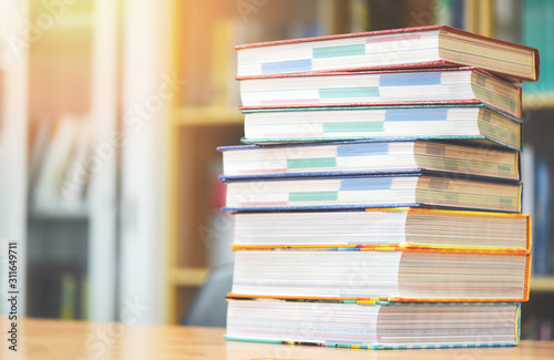 Book education concept back to school and study - stacked books in library on the table
