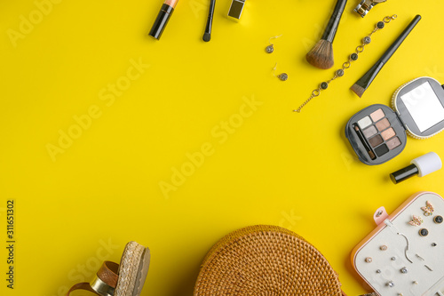 Blogging Beauty Concept. Professional women’s cosmetics, accessories, watches, bracelet, handbag. Female ideas and background. Yellow with space.