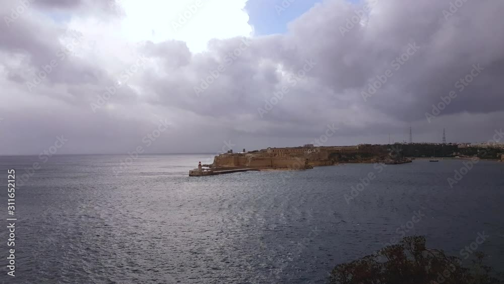 Sea entry to the Port of Valletta in Malta, cloudy day. Static. Sea entry to the Port of Valletta in Malta, cloudy day. Static.
