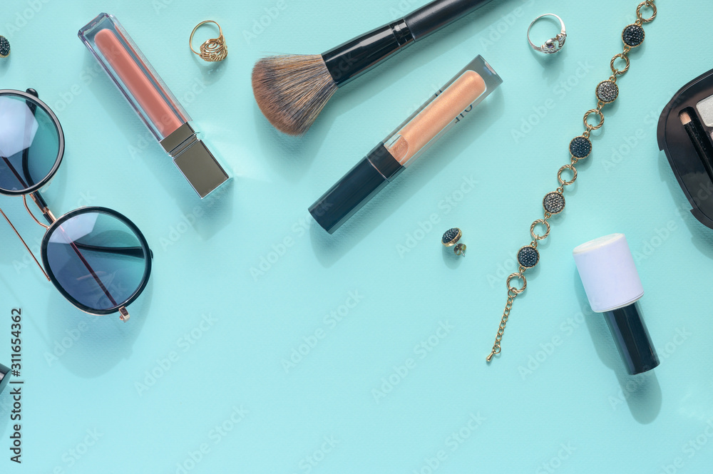 Blogging Beauty Concept. Professional female makeup accessories, watches, bracelet, glasses on a blue background. Female background and fashion. Instagram, women's stuff. Flat lay banner Blogging Beauty Concept. Professional female makeup accessories, watches, bracelet, glasses on a blue background. Female background and fashion. Instagram, women's stuff. Flat lay banner