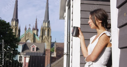 Wallpaper Mural Woman sips coffee in morning while relaxing on rooftop patio - side profile Torontodigital.ca