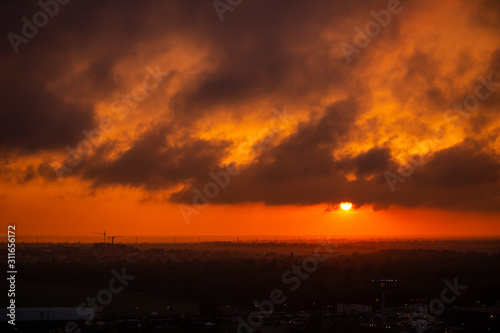 Epic Sunset. Sky. Foggy Clouds. Apocalypse. The sky before a thunderstorm. horizon. Gloomy clouds. End of the world. threat. Epic dramatic sunset