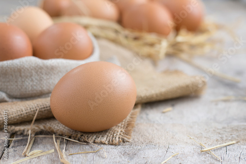Fresh eggs from the farm placed on an old wooden table with copy space