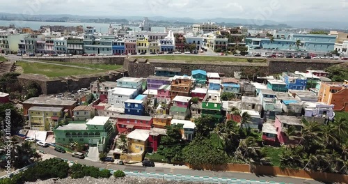 Vibrant La Perla Neighborhood of San Juan, Puerto Rico, Pull Back Aerial. Colorful Houses on Atlantic Ocean Coast photo