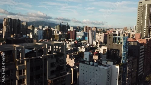 Modern Architecture in Urban Asian Metropolis, Taipei City Taiwan, Cinematic Aerial View on Golden Hour Sunlight photo