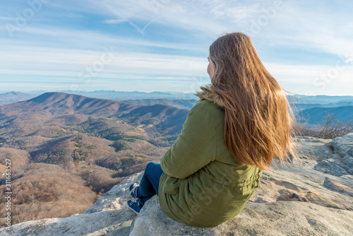 Young woman on the observation point on McAfee Knob photo