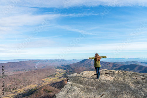Young woman on the observation point on McAfee Knob photo