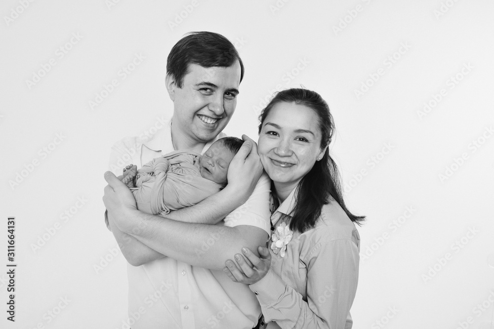 the concept of a healthy lifestyle, the protection of children, shopping - baby in the arms of the mother and father. Woman and man holding a child. Isolated on white background. Copy space the concept of a healthy lifestyle, the protection of children, shopping - baby in the arms of the mother and father. Woman and man holding a child. Isolated on white background. Copy space