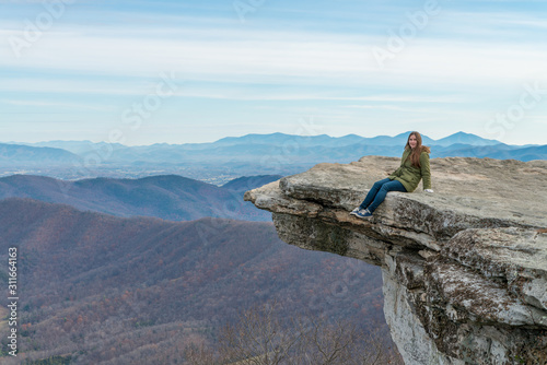 Young woman on the observation point on McAfee Knob