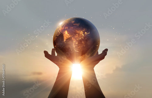 Fototapeta Naklejka Na Ścianę i Meble -  Earth at night was holding in human hands. Earth day. Energy saving concept, Elements of this image furnished by NASA