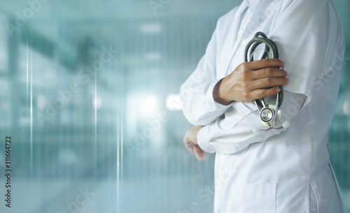 Medicine doctor with stethoscope in hand on hospital background,  Medical technology, Healthcare and Medical concept. photo