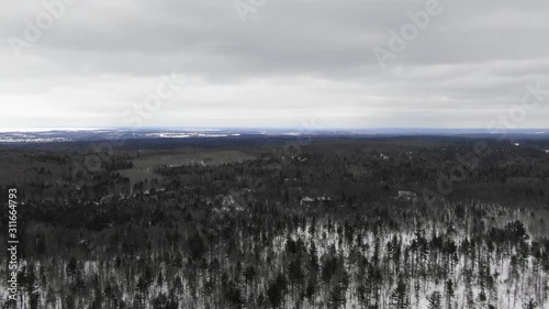 Winter party in the woods in Traverse City Michigan 4K drone shots over forest and open woods in winter snow covered scene logo here photo