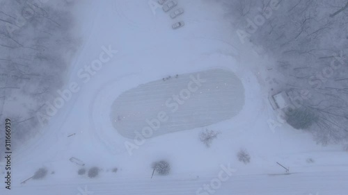 Winter in Northern Michigan in Charlevoix Playing Ice Hockey Pond rink 4K drone shots over forest and open woods in winter snow covered scene ready to play photo