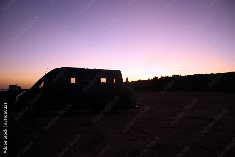 Camper with a clear sky during sunrise
