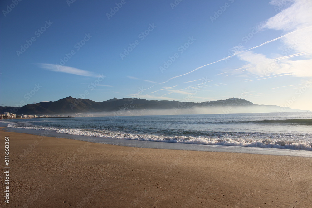 Beach with foggy waves in the morning