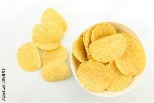 potato chips on bowl on white background.