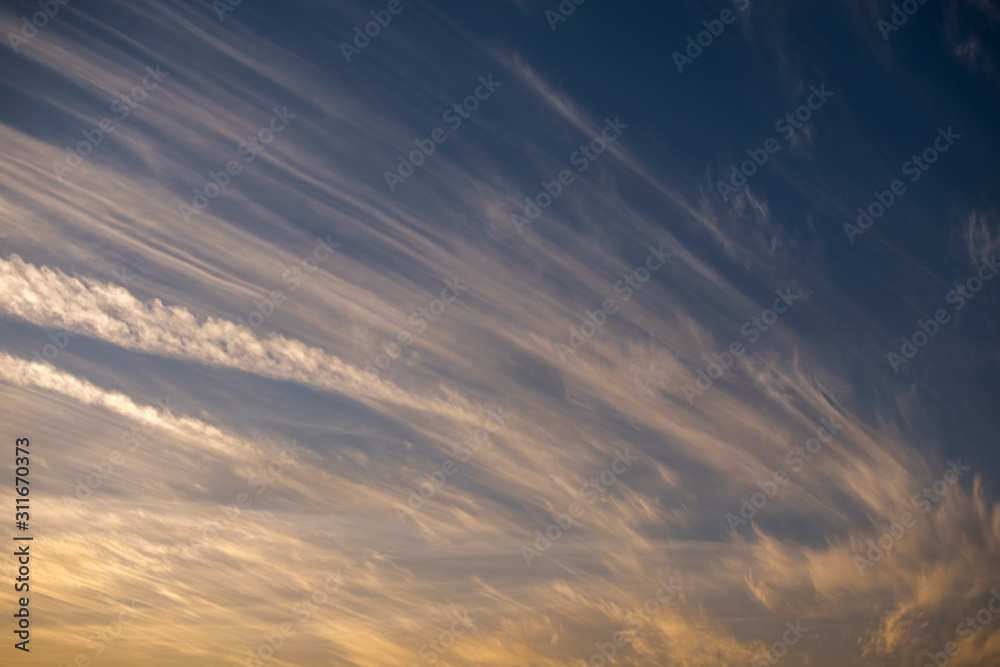Obraz premium Clouds wave with sun light orange and blue sky in the evening ,Twilight sky background.